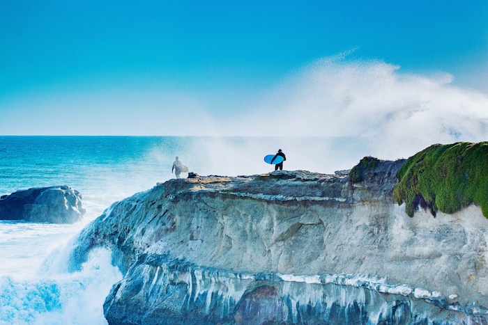 Surfers prepare to jump into the ocean at Steamer Lane, Santa Cruz California